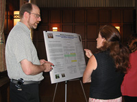 [PHOTO] Dean Grosshandler and Cindy Passmore discussing a poster presentation at the 2006 KSI.
